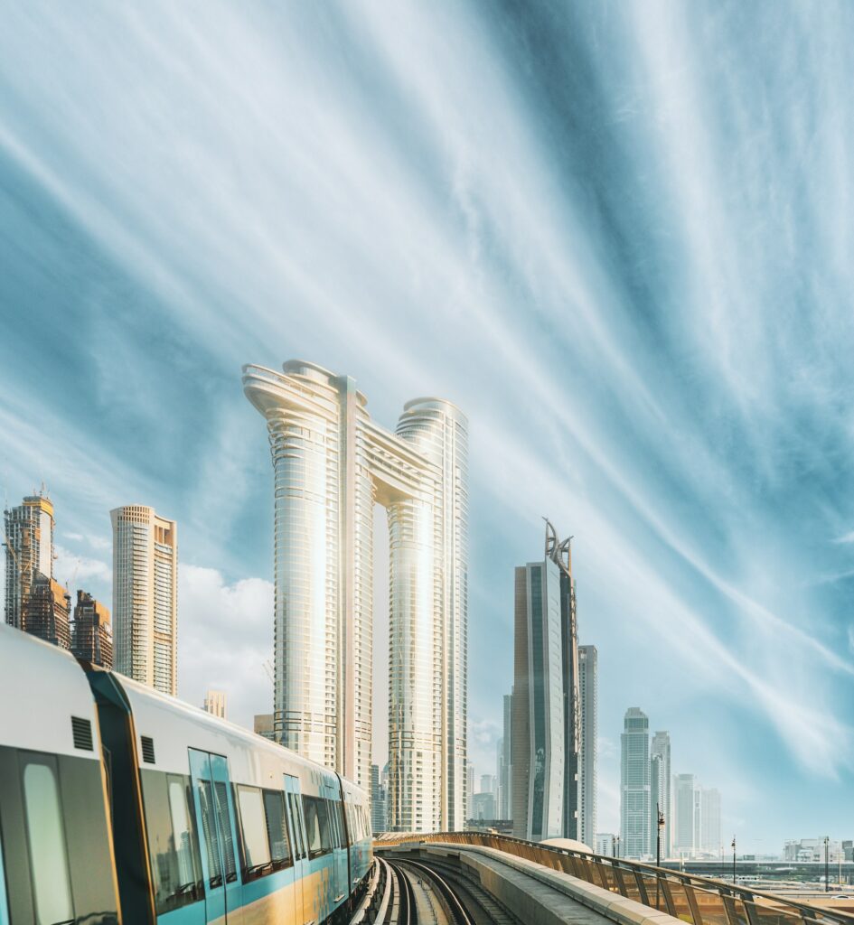 Monorail Subway Train Rides Among Glass Skyscrapers In Dubai. Traffic On Street In Dubai. Cityscape